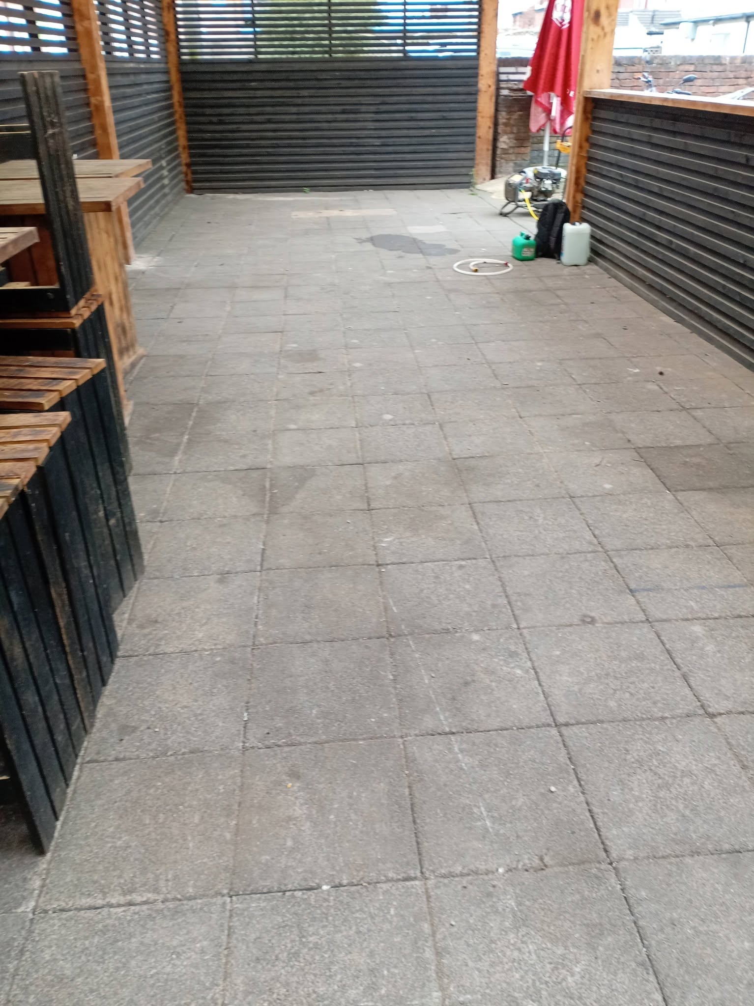 Dirty, stained grey patio slabs before pressure washing